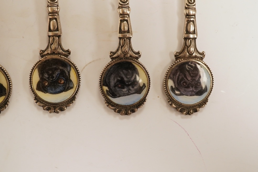 A matched set of six mainly George V silver/white metal and enamel teaspoons, with terminals decorated with dog's heads, 13.6cm. Condition - fair